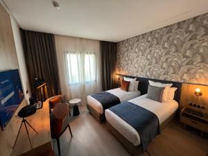 Letto o letti in una camera di Hotel Ben Batouta - Tanger