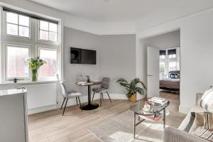 a white living room with a table and chairs at The Abingdon in London