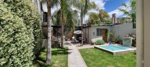 a backyard with a swimming pool and a house at 166 1/2 in La Cieneguita