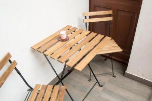 a wooden table and chair with a cup of coffee on it at HOLI in Toruń