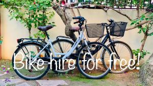 two bikes parked next to each other next to a tree at GREEN LAGOON in Calpe