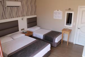 Кровать или кровати в номере Ida Hotel