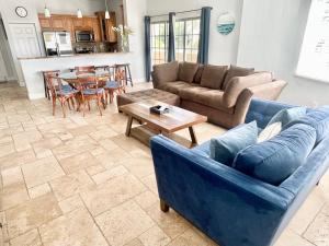 a living room with a couch and a table at Vistalmar Beach Resort in Deerfield Beach