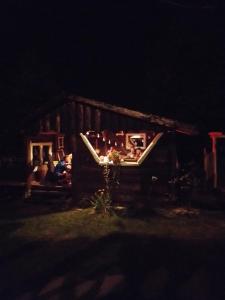 a group of people sitting in a house at night at Małopolskie Swojskie in Olszyny
