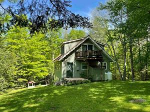 a small green house in the middle of a yard at 5 bdrm Creekside Chalet located near 4 ski resorts in Weston