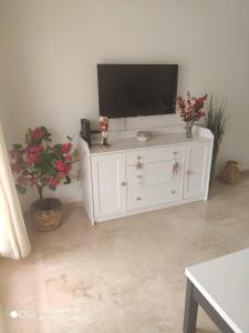 un armario blanco con un televisor encima. en APARTAMENTO CASARES PLAYA, en San Luis de Sabinillas