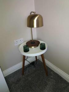 a small table with a lamp on top of it at Dún Eoin Carrigaline in Carrigaline