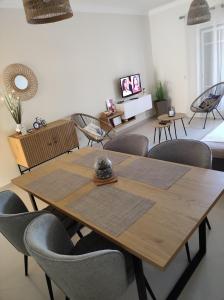 uma sala de jantar com uma mesa de madeira e cadeiras em Casa Brisa do Mar em Porches