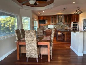 a kitchen with a wooden table and chairs at Luxurious Home in Wailea in Wailea
