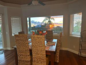 a dining room with a table and chairs and a window at Luxurious Home in Wailea in Wailea