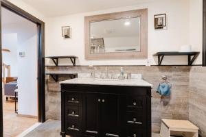 a bathroom with a sink and a mirror at Private estate apartment. in Glen Head