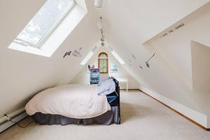 a bedroom with a bed in a attic at Private estate apartment. in Glen Head