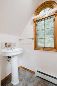 a bathroom with a sink and a window at Private estate apartment. in Glen Head