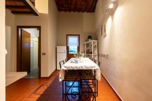 a dining room with a table and a refrigerator at Apartment Anfiteatro in Lucca