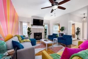 a living room with blue couches and a fireplace at Your UF Getaway: 1 Block from Campus - 4 BD Haven in Gainesville