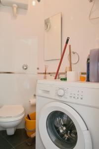een witte wasmachine in een badkamer met een toilet bij Central Apartment, Is-Swieqi in Is-Swieqi