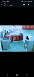 a kitchen with a stove and a refrigerator at Chloe Isla Apartment Malindi. in Malindi