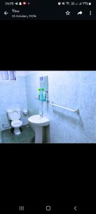 a bathroom with a white sink and a toilet at Chloe Isla Apartment Malindi. in Malindi