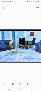 a living room with a couch and a table at Chloe Isla Apartment Malindi. in Malindi