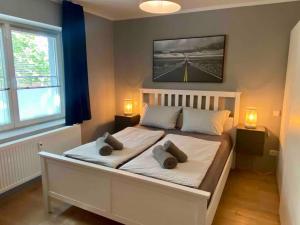 a bedroom with a large white bed with two pillows at Apartment in Potsdam-Babelsberg in Potsdam