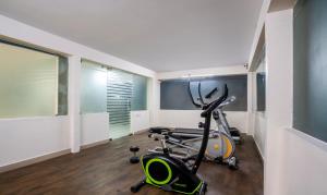 a gym with a exercise bike in a room at Treebo Trend Emerald in Hyderabad