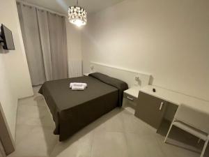 a bedroom with a bed with two towels on it at La Dimora del Maggio in Accettura