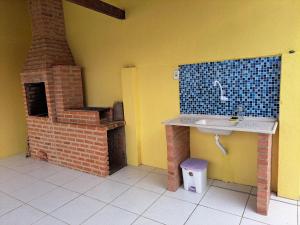 y baño con lavabo y horno de ladrillo. en 3 QTS Churrasqueira Garagem perto do Forte e Ilha do Japonês, en Cabo Frío