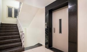 a hallway with a staircase and a door at Treebo Emerald in Hyderabad