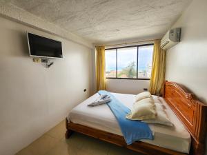 Postel nebo postele na pokoji v ubytování Hostal Poseidon