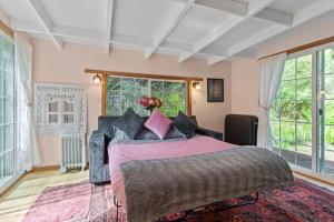 a bedroom with a large bed in a room with windows at Spacious Serene Sanctuary- 14 min to Muir Woods in Mill Valley