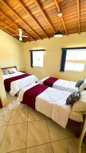 a bedroom with three beds in a room at Pousada Antares de Paraty in Paraty