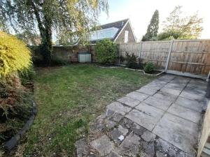 a backyard with a wooden fence and a patio at Grace's Place in Soham in Soham
