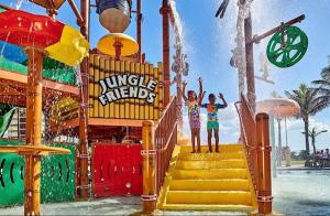 two girls standing on stairs at a water park at Precious Paradise Ushaka in Durban