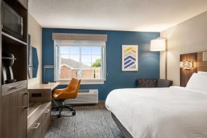 鮑靈格林的住宿－鮑靈格林智選假日酒店，配有一张床、一张书桌和一扇窗户的酒店客房