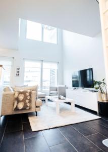 a living room with a couch and a tv at Apartment next to Ounasvaara and city centre in Rovaniemi