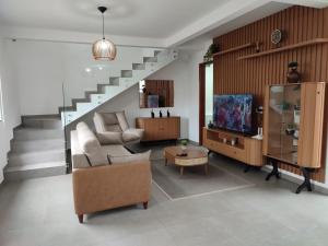 a living room with a couch and a staircase at CASA DE PRAIA in Garopaba