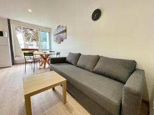 a living room with a couch and a table at cosy douillet la grande motte in La Grande-Motte +4 photos