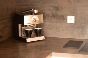 a coffee maker sitting on a counter with two cups at Tignes Le Lac - Appartement au pied des pistes (6 personnes) in Tignes