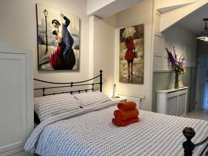 a bedroom with a bed with two paintings on the wall at Bonsalls Central Hebden Bridge in Hebden Bridge