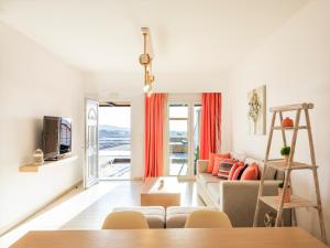 a living room with a couch and a table at Villa Evi & Suites in Mikonos