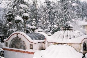 a snow covered house with a gazebo at CAN APART KAPLICA OTEL in Termal