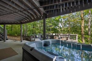 a large bath tub sitting on a patio at Water's Edge-Lakefront Cabin W/Dock, Views, Etc. in Winchester