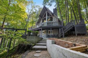 a house with a staircase leading up to it at Water's Edge-Lakefront Cabin W/Dock, Views, Etc. in Winchester