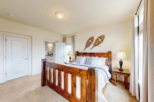 a bedroom with a wooden bed and a window at Cottonwood Pass Retreat in Gypsum