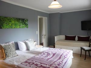 a bedroom with a bed and a tv on the wall at Landfein Big Country House in Winterberg