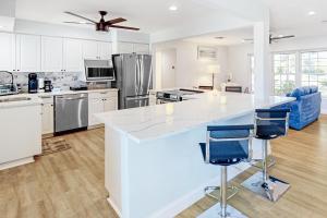 a large kitchen with a large white counter top and appliances at Seminole's Secret in Redington Shores