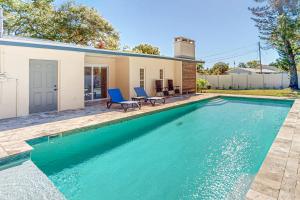 a swimming pool in front of a house at Seminole's Secret in Redington Shores