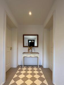 a room with a table and a mirror on the wall at Villa Rosenhof (2 Personen +) in Lindau