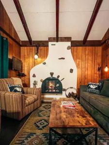 a living room with a couch and a fireplace at Mountain Top Chalet ~ Ski In Out ~ Fully Updated in Bessemer
