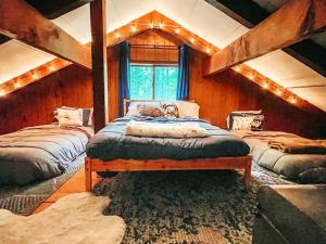 a bedroom with two beds with a dog laying on it at Mountain Top Chalet ~ Ski In Out ~ Fully Updated in Bessemer